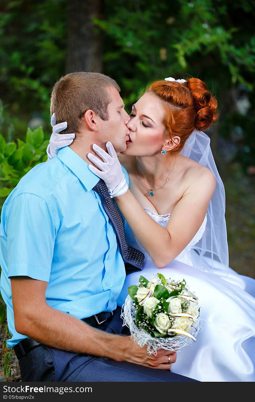 Passionate Wedding Kiss in a Summer City Park