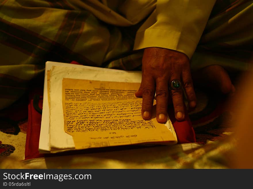 An old man most probably the bride's farther reciting pre-wedding agreement during the Malay Muslim wedding ceremony