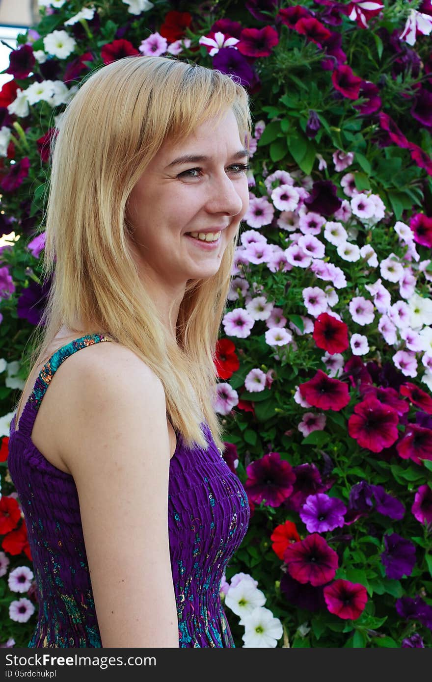 Smiling girl on the background of garden flowers. Smiling girl on the background of garden flowers