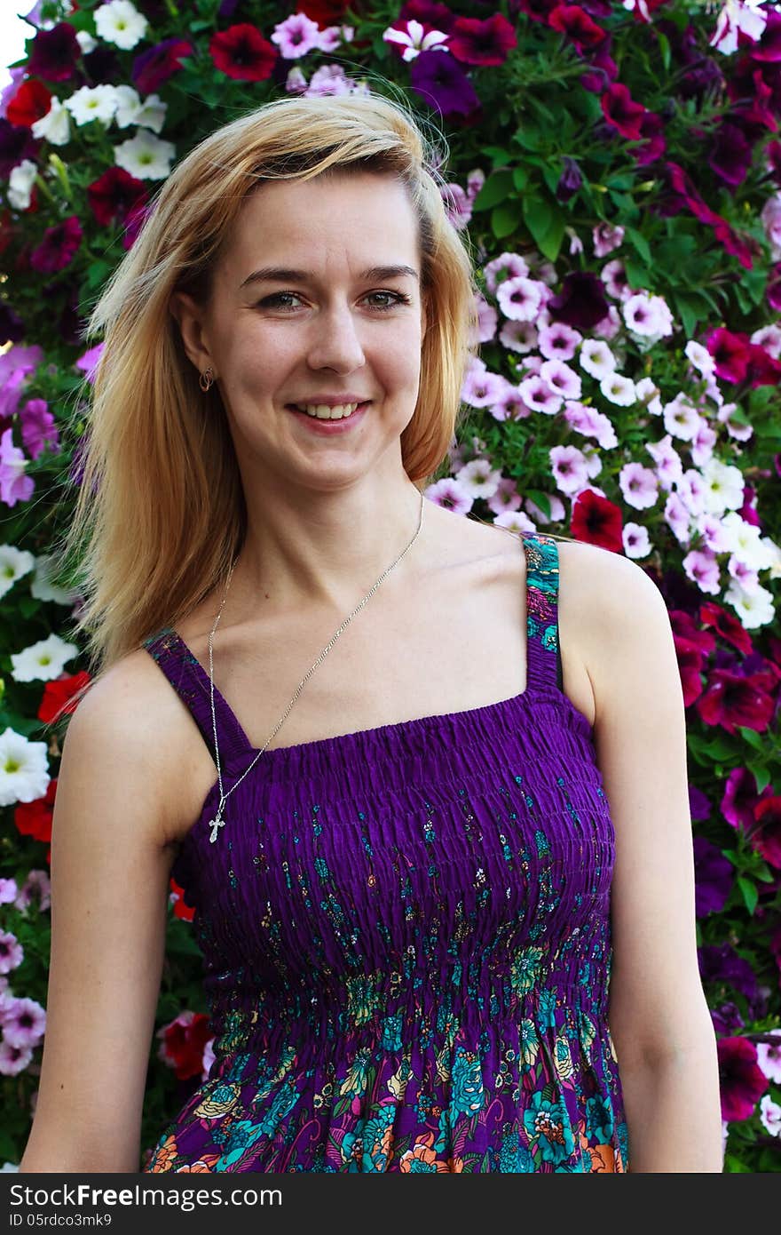 Smiling girl on the background of garden flowers. Smiling girl on the background of garden flowers