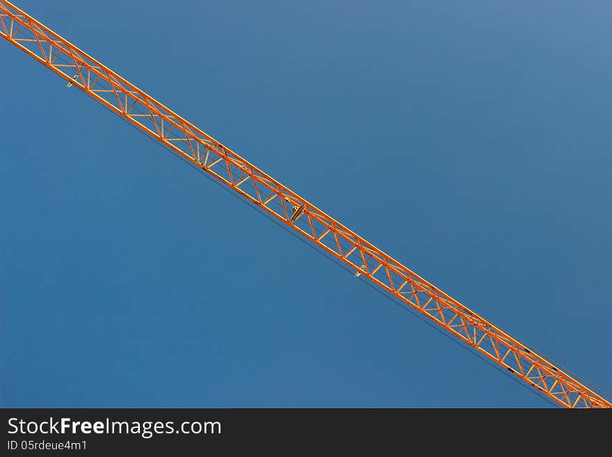 The steel structure, truss of a crane over blue sky. The steel structure, truss of a crane over blue sky