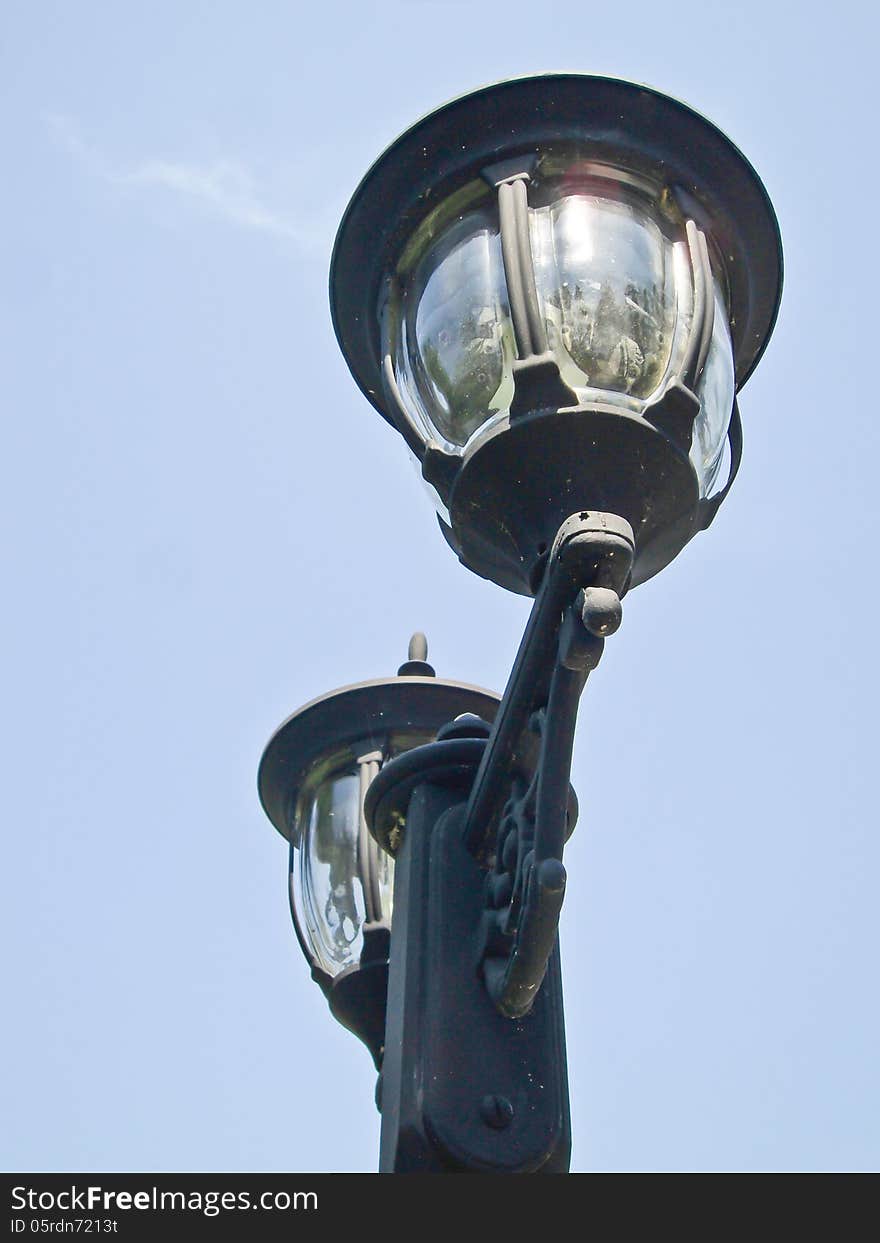 Light poles on street in park