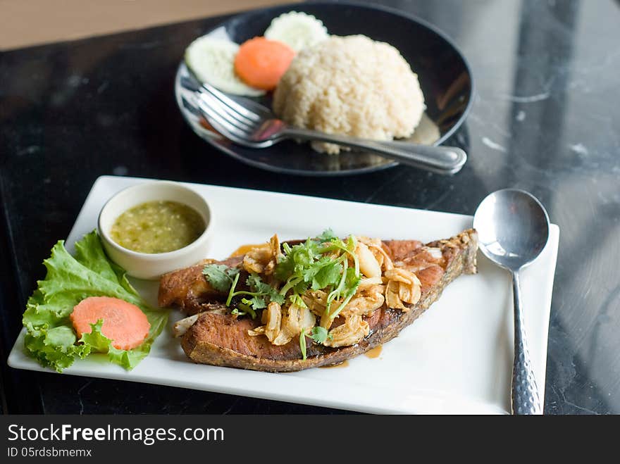 Piece of deep fried fish serve with spicy sauce and rice. Piece of deep fried fish serve with spicy sauce and rice