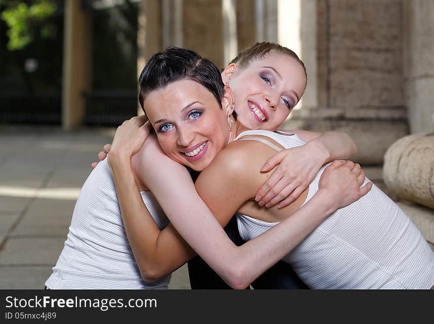 Family, mother and daughter hugging on a walk through the city