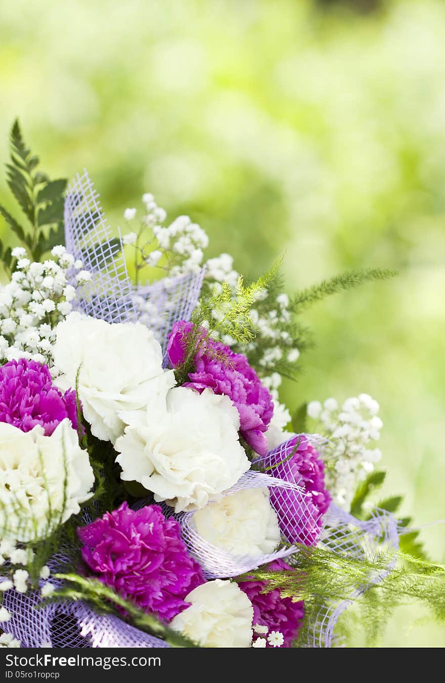 Close up on colorful wedding bouquet made of red and purple flowers