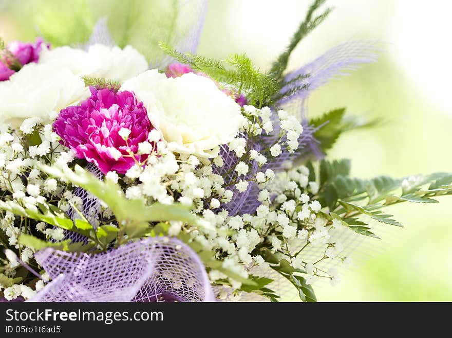 Close up on colorful wedding bouquet made of red and purple flowers