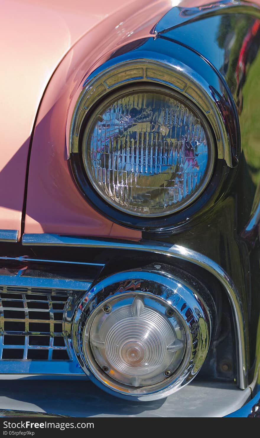 Closeup of a Vintage Pink Classic American Car headlights. Closeup of a Vintage Pink Classic American Car headlights.