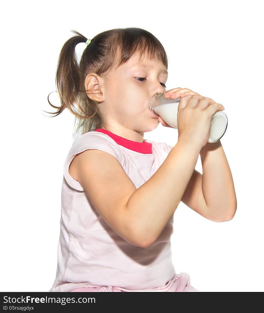 Cute little girl is drinking milk from bottle isolated on white