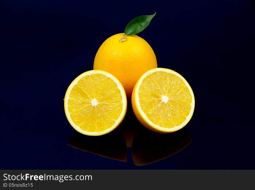 The photograph shows orange fruit placed on a blue background. The photograph shows orange fruit placed on a blue background.