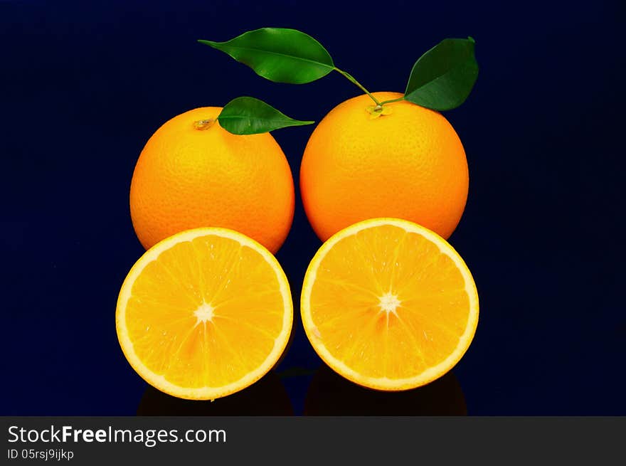 The photograph shows orange fruit placed on a blue background. The photograph shows orange fruit placed on a blue background.