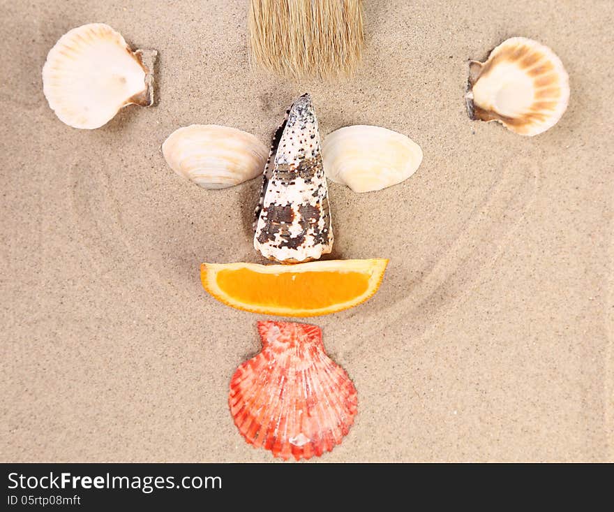 Mug made ??of shells, brush and orange slices on the sand. Mug made ??of shells, brush and orange slices on the sand