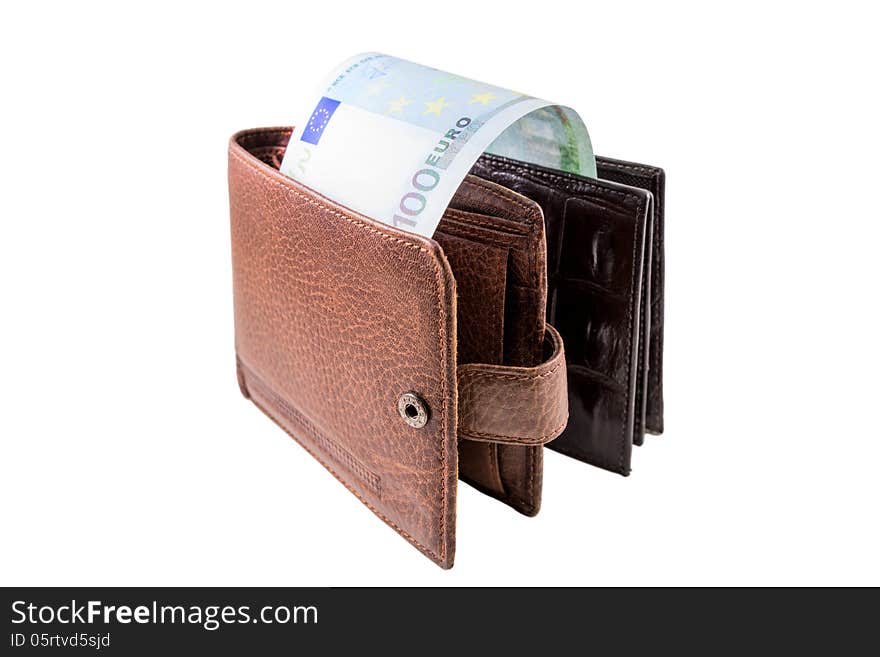 The brown leather wallet with euro is photographed on the close-up