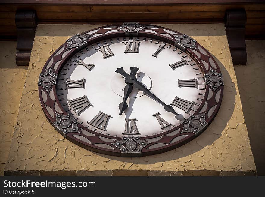 Old vintage style clock on textured yellow wall. Old vintage style clock on textured yellow wall