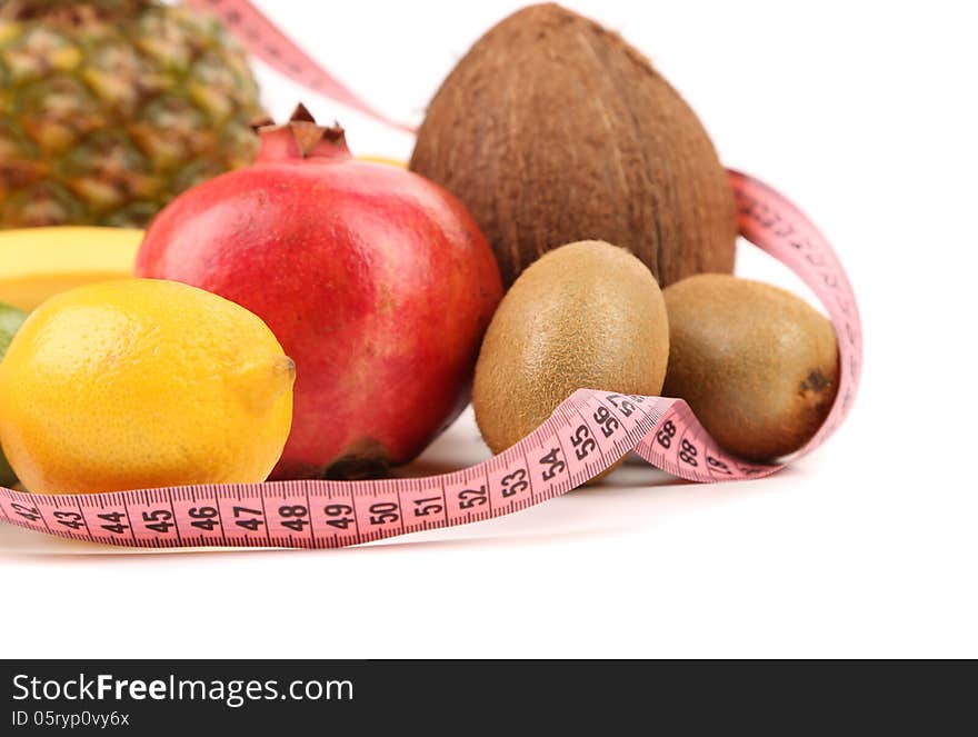 Tape measure and fruits composition isolated on a white background