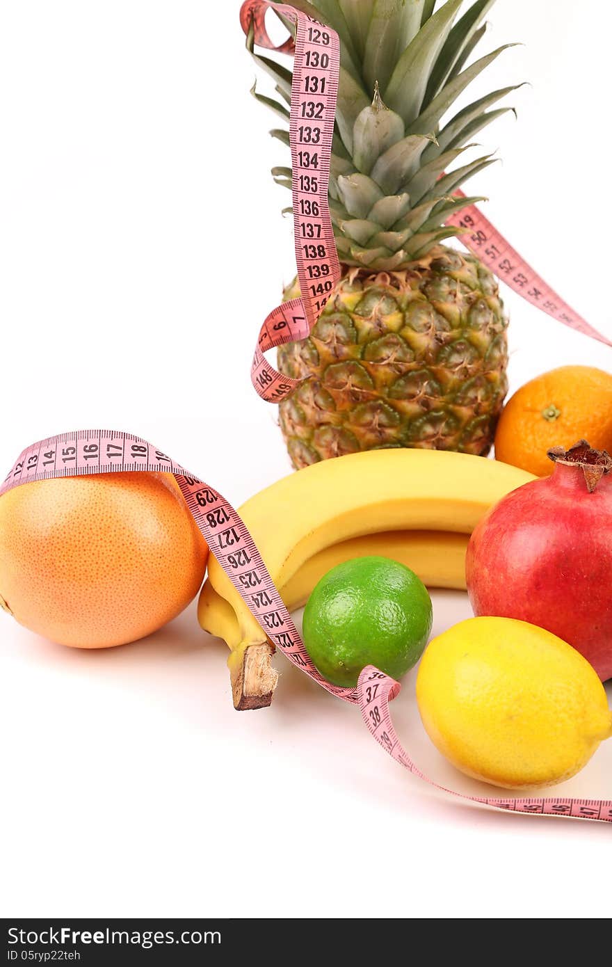 Tape measure and fruits composition isolated on a white background