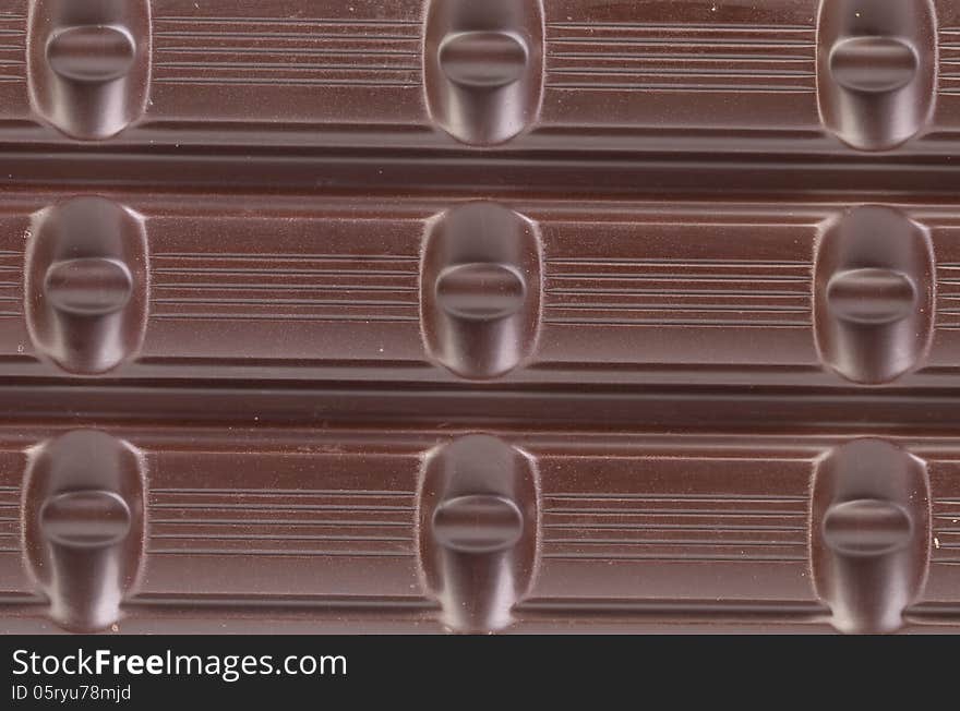 Dark chocolate bar as background.