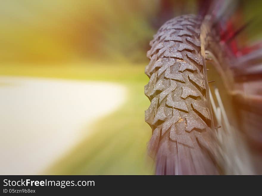 Bike wheel on the country road in the motion