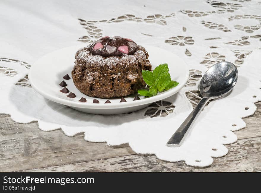 Diet chocolate cupcakes on yeliow plate mint leaf