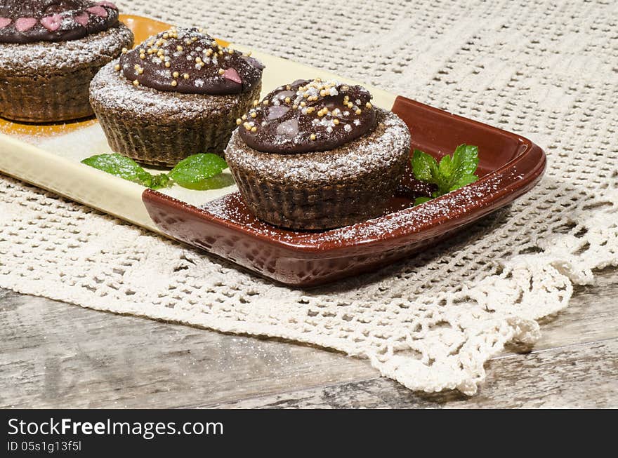 Diet chocolate cupcakes on a plate decorated with chocolate. From the series Recipes for diet Ducane. Diet chocolate cupcakes on a plate decorated with chocolate. From the series Recipes for diet Ducane