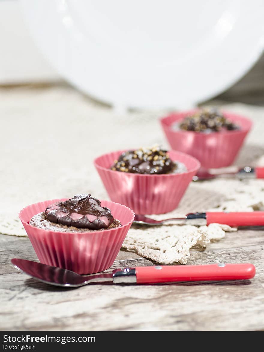 Diet chocolate cupcakes and three spoons. Vertical format