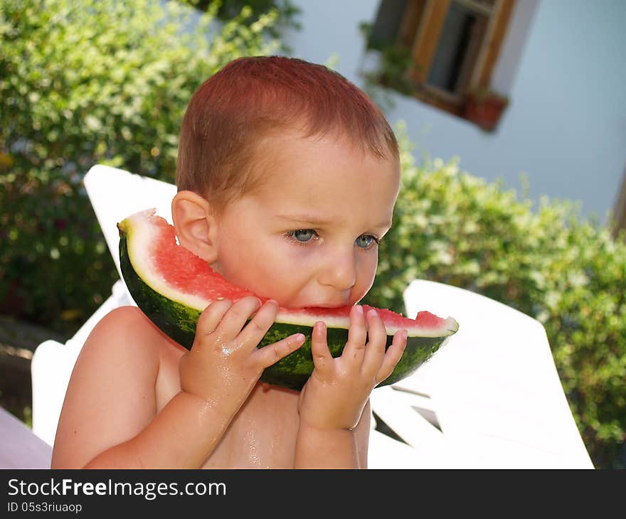 Baby eat watermelon in village house garden. Baby eat watermelon in village house garden