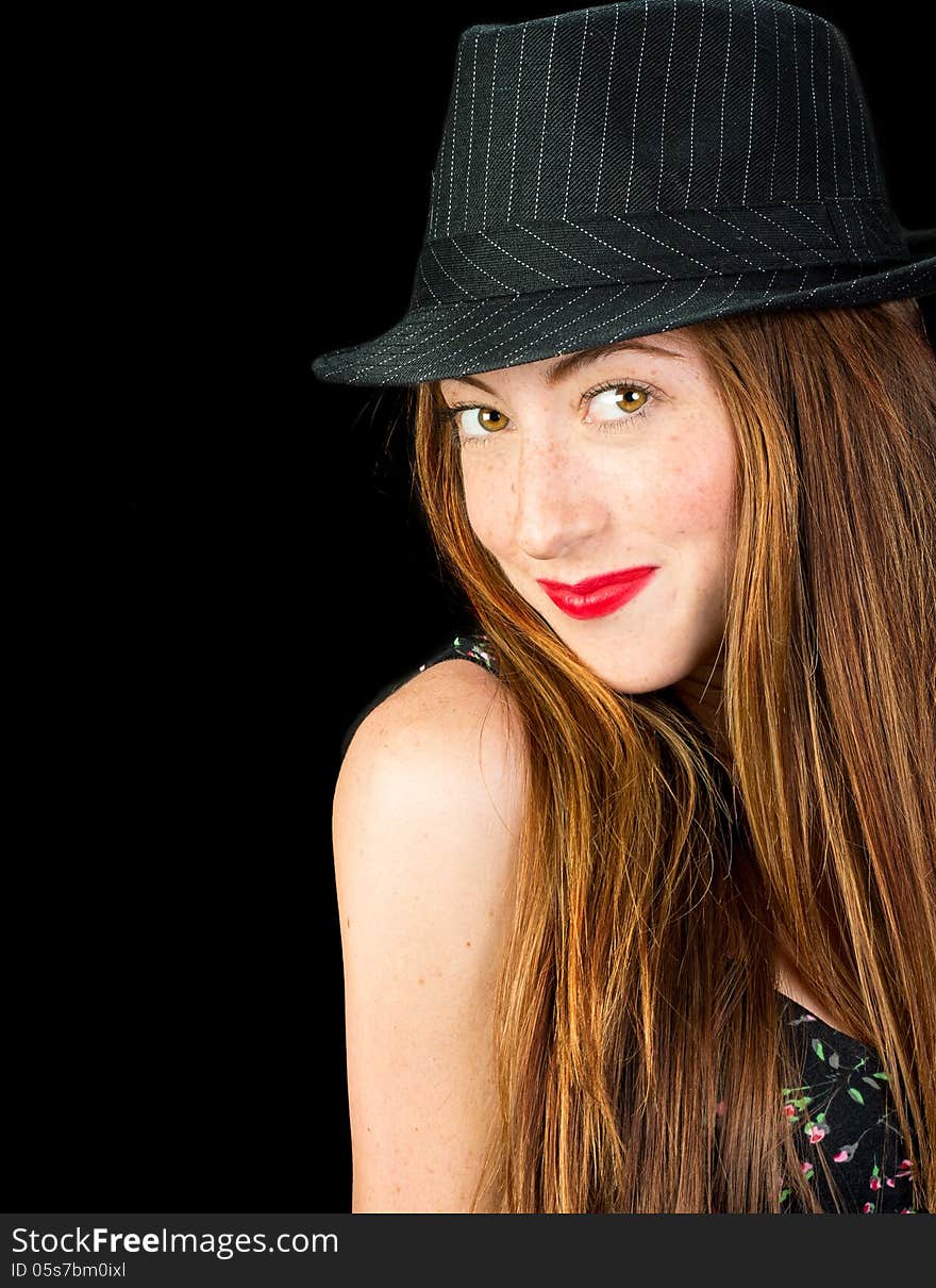 Beautiful young woman with hazel eyes and gorgeous long red hair wearing a pinstriped fedora smiling. Beautiful young woman with hazel eyes and gorgeous long red hair wearing a pinstriped fedora smiling