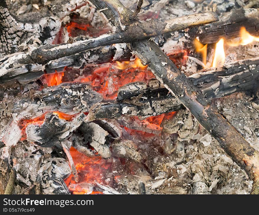 Bonfire closeup with focus on front branches