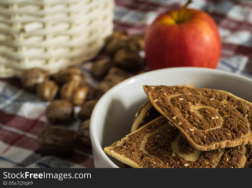 Cookies, apple with basket on the cloth. Cookies, apple with basket on the cloth