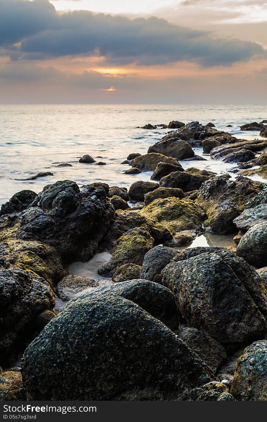 Rocky beach with sunset from westcoast of phuket