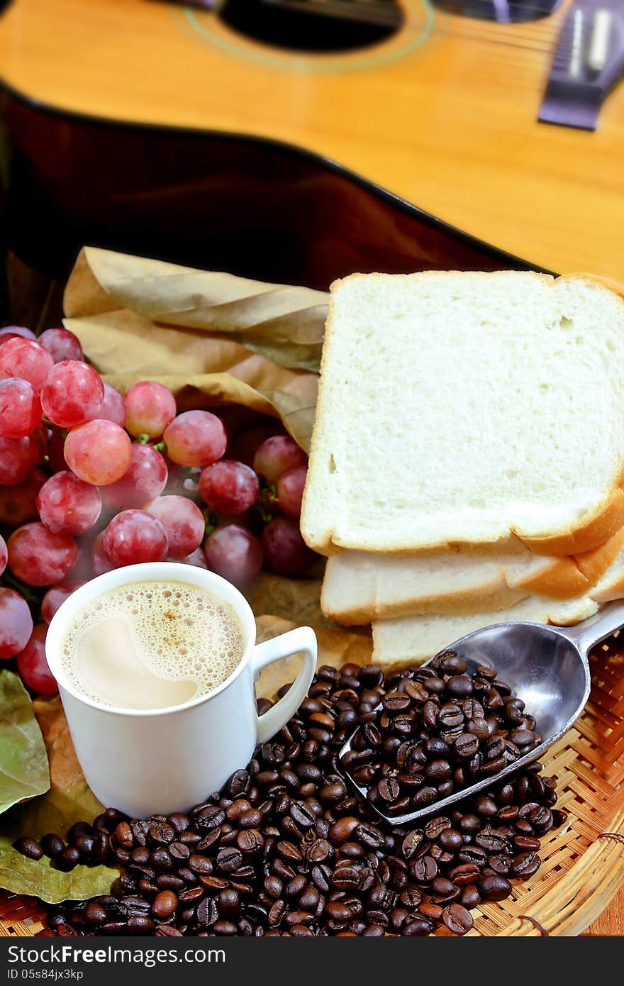 Coffee with fresh grapes,bread,coffee beands on basket background. Coffee with fresh grapes,bread,coffee beands on basket background