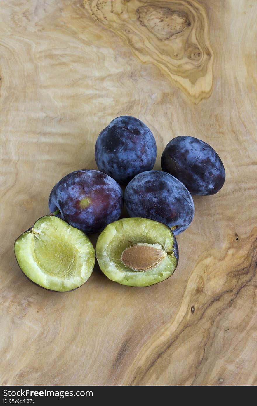 Fresh plums on a wooden board