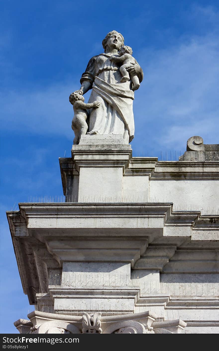 Statue At The Top Of A Neoclassic Building