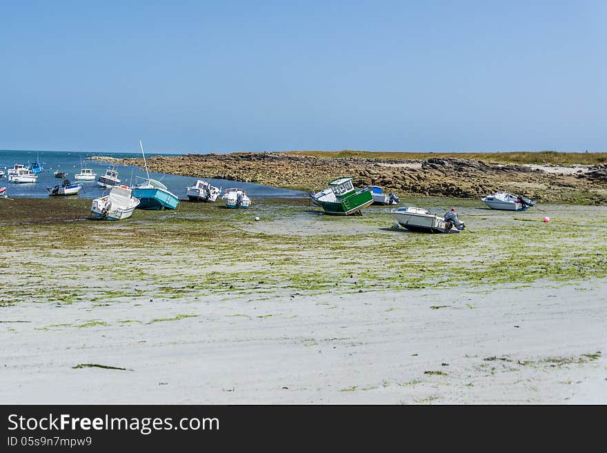 Boats laying on dry land as a result of low tide