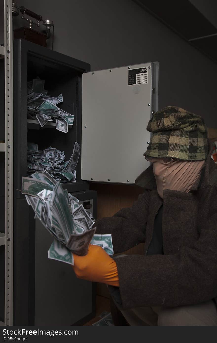 A thief steals money from the safe