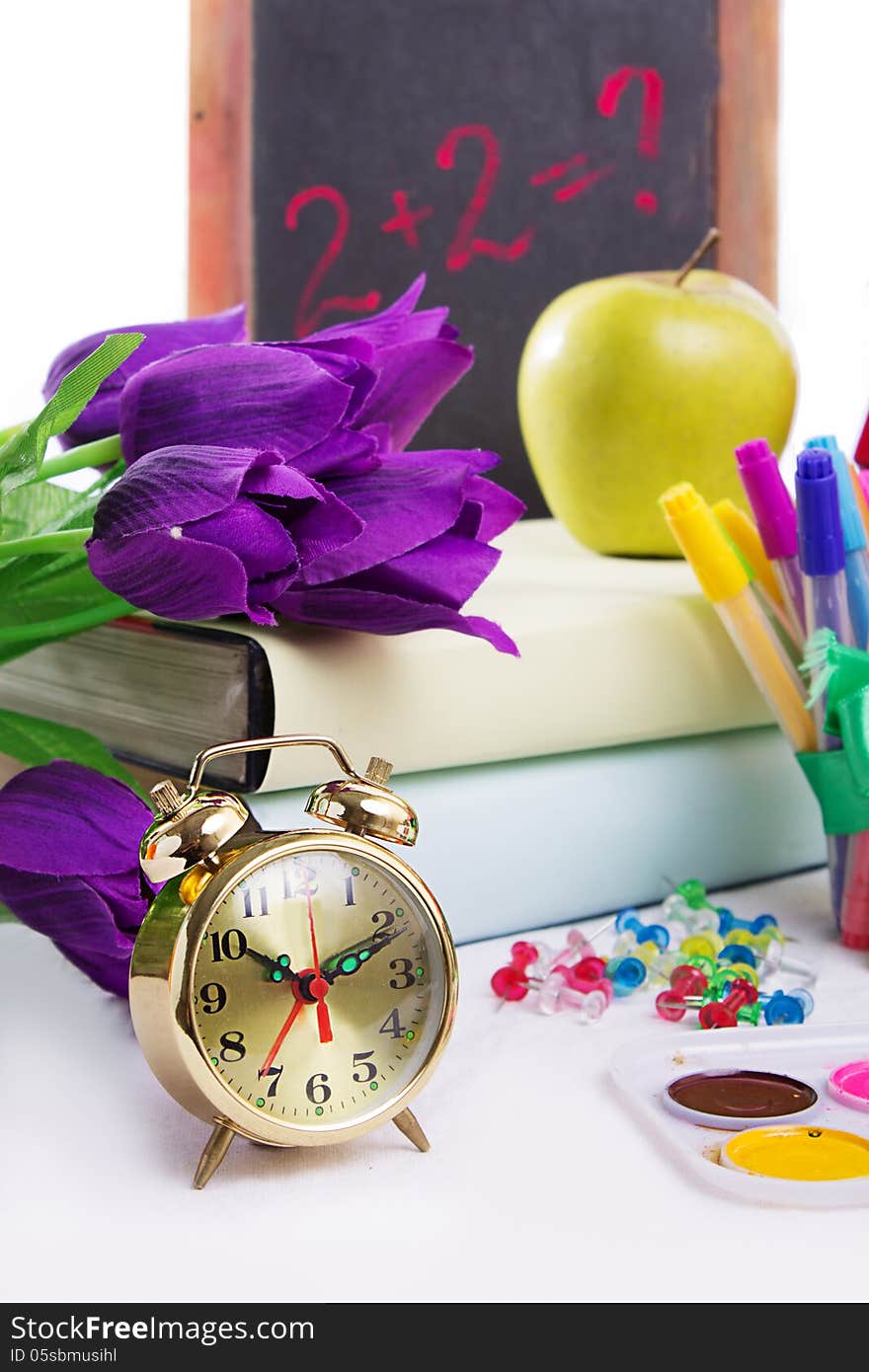 Clock, flowers and apple, back to school concept