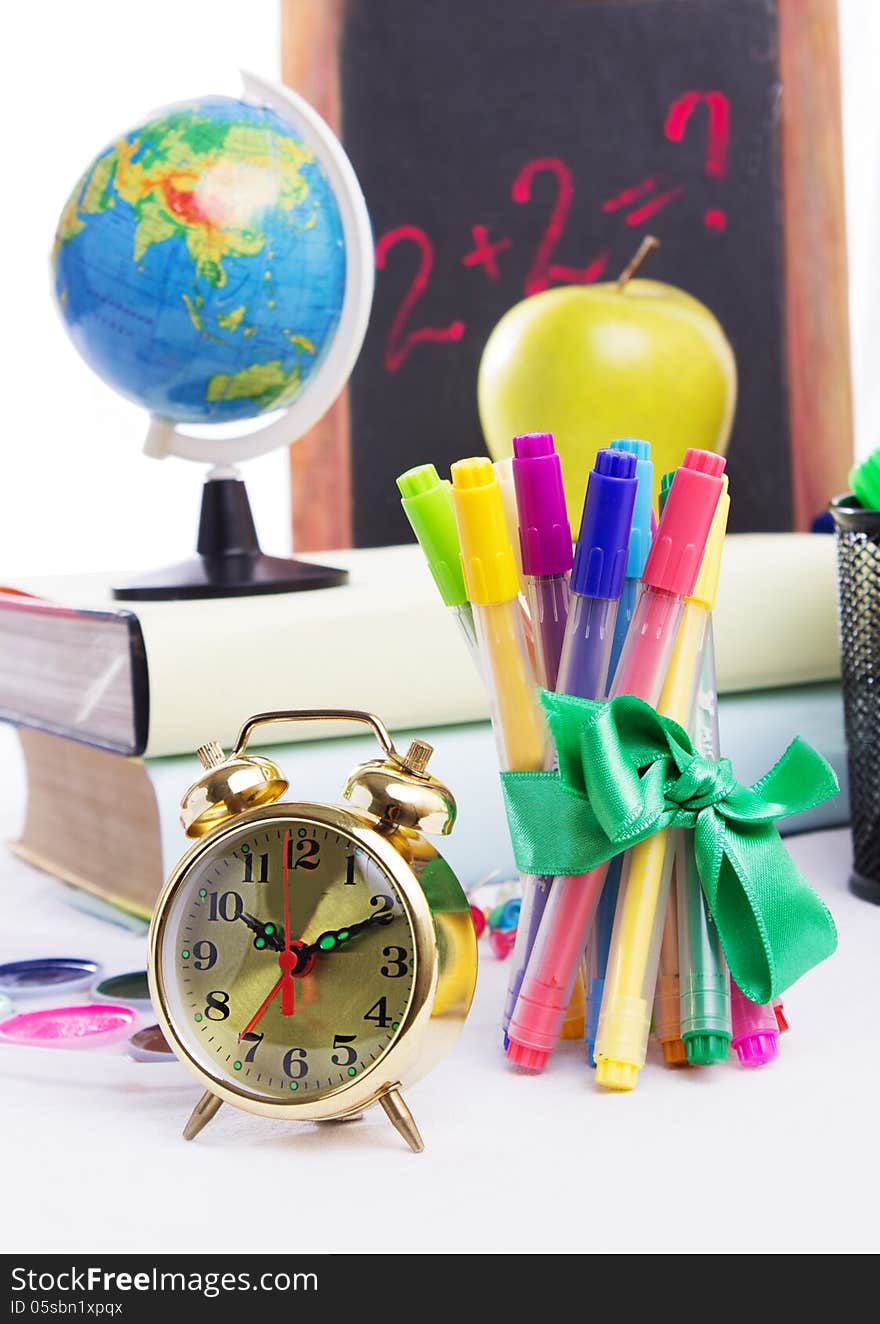 Some school stationary with clock isolated on white. Some school stationary with clock isolated on white