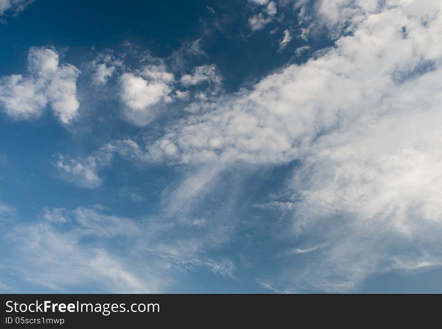 White fluffy clouds in the blue sky. White fluffy clouds in the blue sky