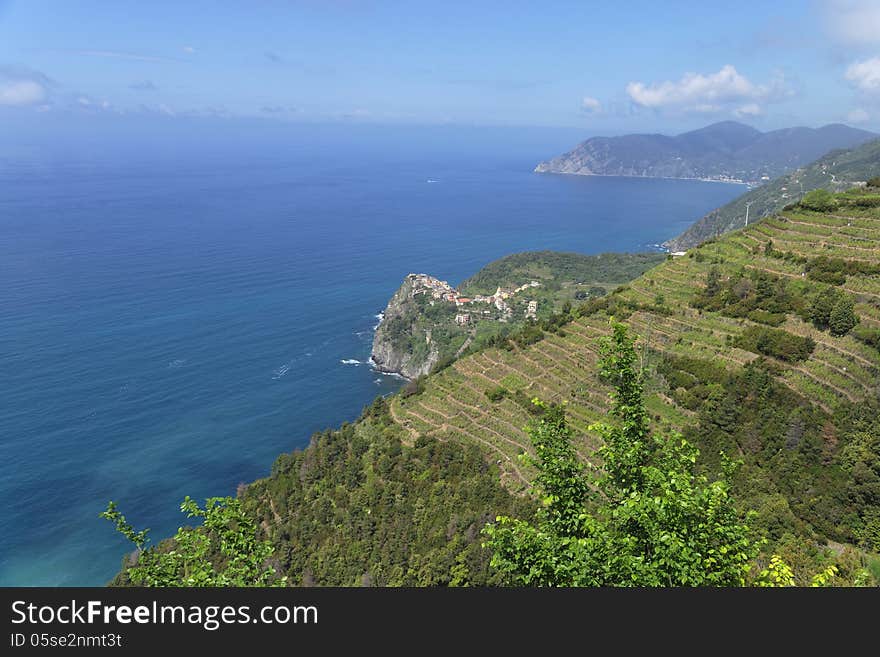 Corniglia is part of the commune of Vernazza in the province of La Spezia in Liguria in northern Italy. Unlike the other localities of the Cinque Terre, Corniglia is not directly adjacent to the sea. Instead, it is on the top of a promontory about 100 metres high, surrounded on three sides by vineyards and terraces and the fourth side descends steeply to the sea. Corniglia is part of the commune of Vernazza in the province of La Spezia in Liguria in northern Italy. Unlike the other localities of the Cinque Terre, Corniglia is not directly adjacent to the sea. Instead, it is on the top of a promontory about 100 metres high, surrounded on three sides by vineyards and terraces and the fourth side descends steeply to the sea.