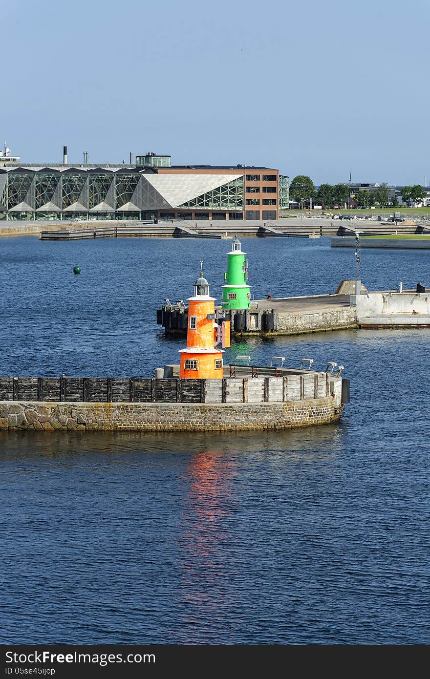 The old town of Helsingoer in Denmark is also an important ferry port that connects Denmark with the Swedish town of Helsingborg. The red and green mini-lighthouses mark the entrance to Helsingoer harbour. The old town of Helsingoer in Denmark is also an important ferry port that connects Denmark with the Swedish town of Helsingborg. The red and green mini-lighthouses mark the entrance to Helsingoer harbour.