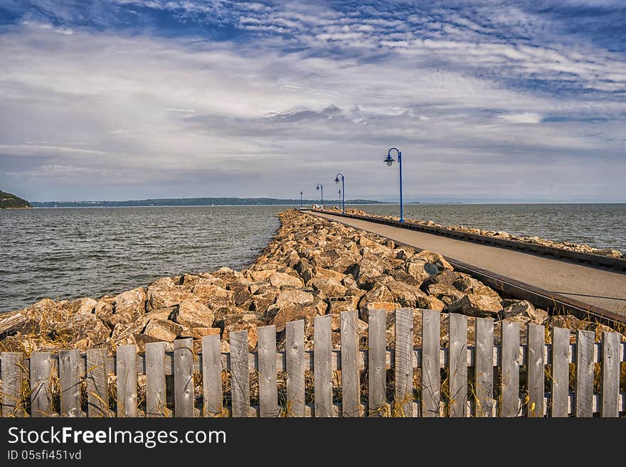 Quay with lamppost rocks and fence