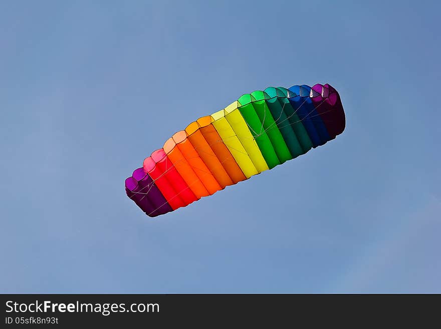 Colorful big kite in blue sky