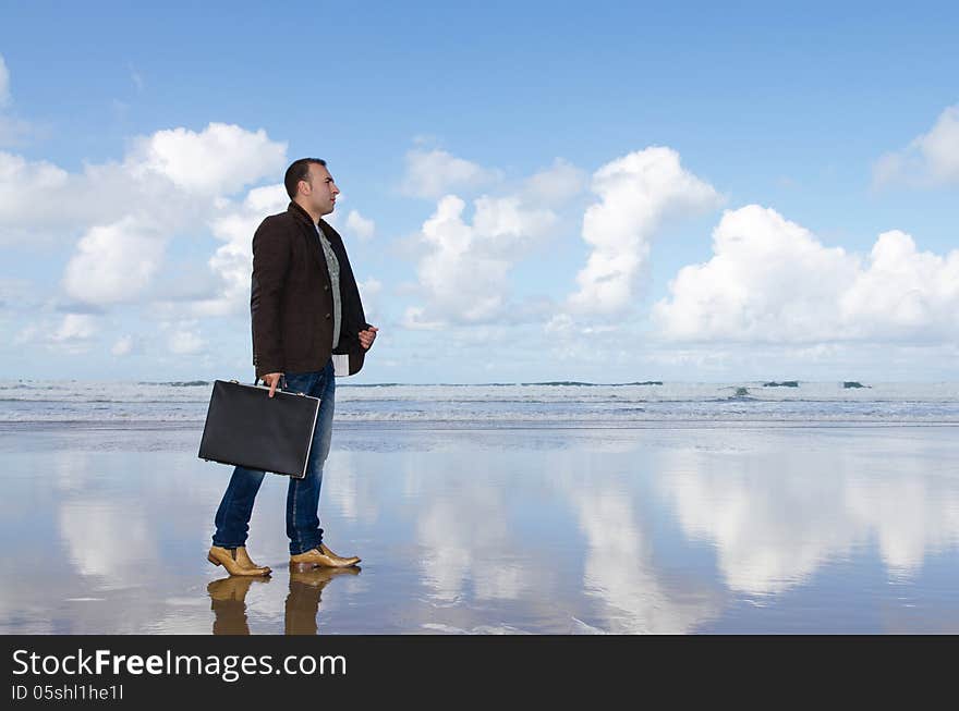 Businessman lost on the beach.