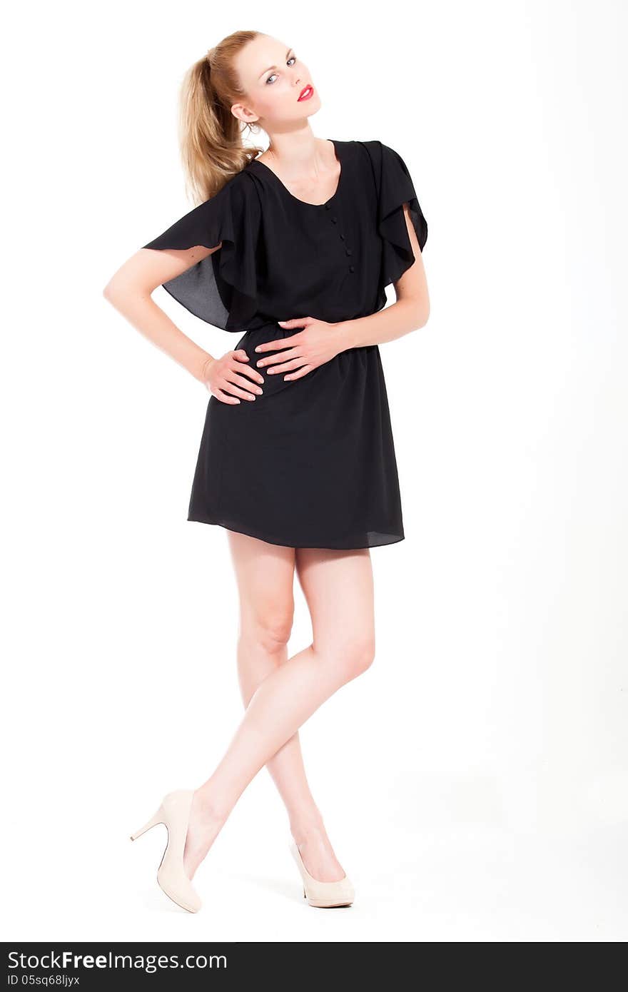 Beautifull young blond woman in the studio with a black dress. Beautifull young blond woman in the studio with a black dress