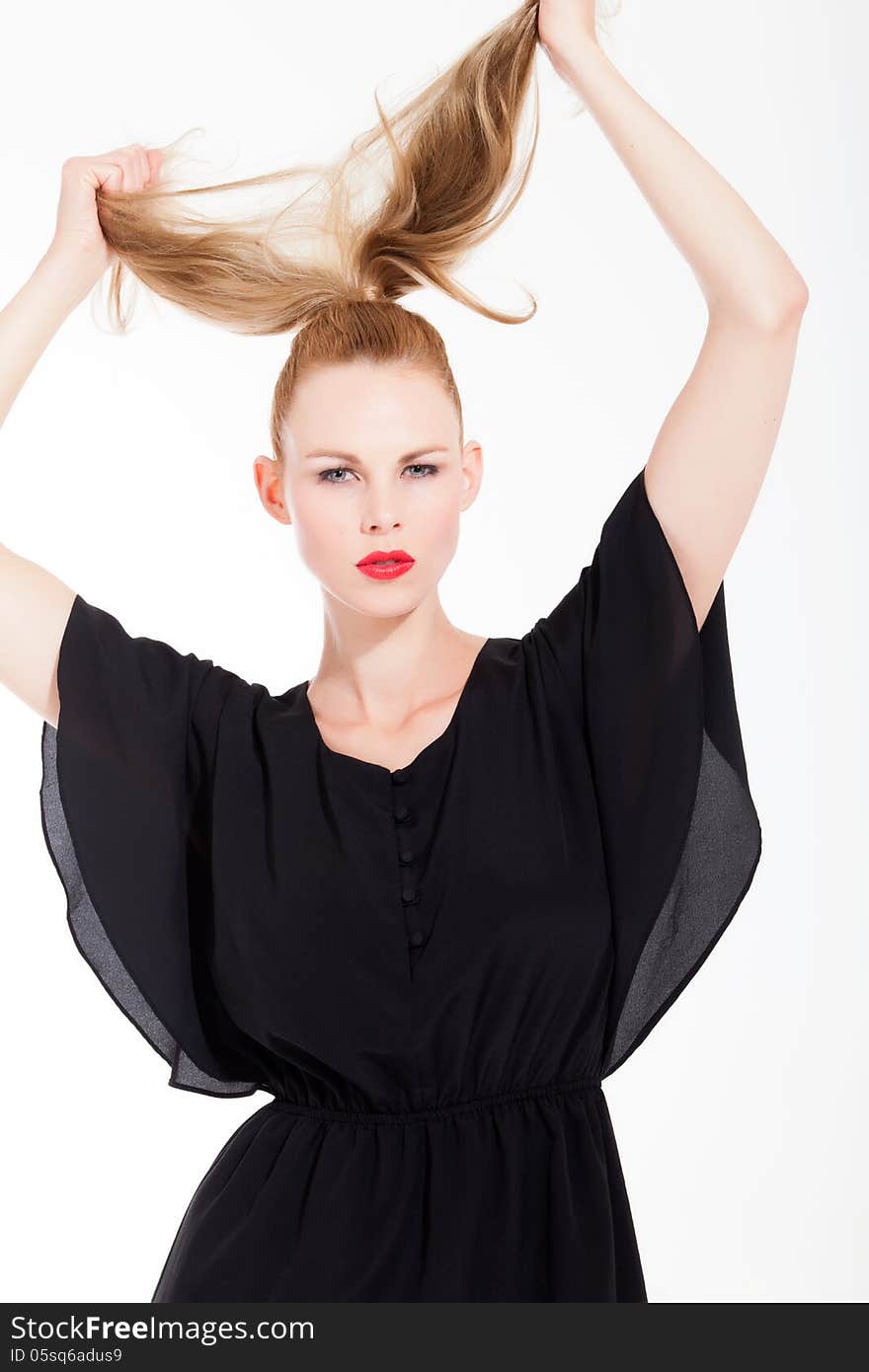 Beautifull young blond woman in the studio with a black dress. Beautifull young blond woman in the studio with a black dress