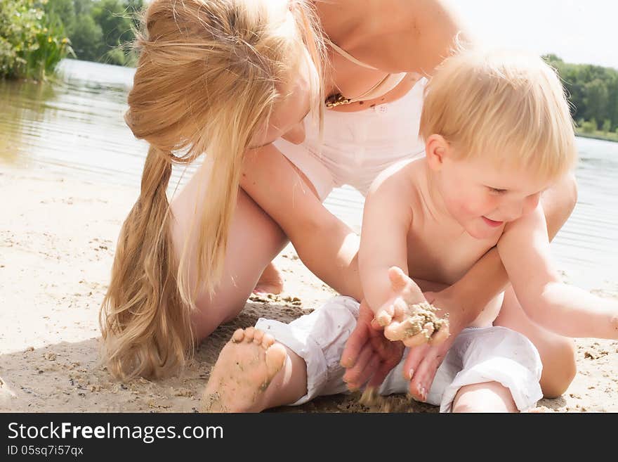 Happy mother and son having a nice day at the beach. Happy mother and son having a nice day at the beach