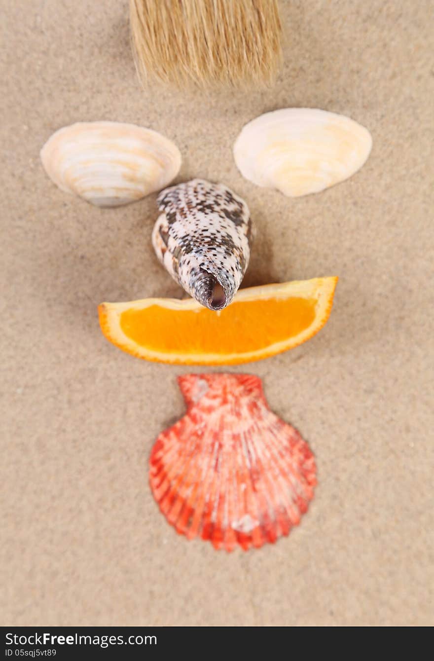 Mug made ??of shells, brush and orange slices on the sand. Mug made ??of shells, brush and orange slices on the sand