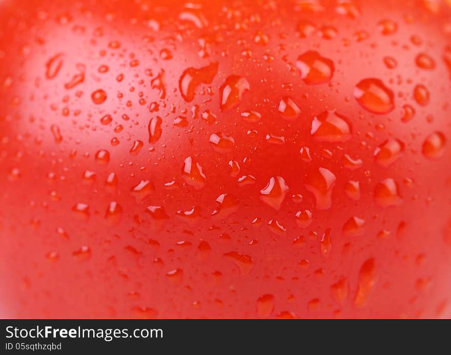 Water drops on red tomato. Close up.