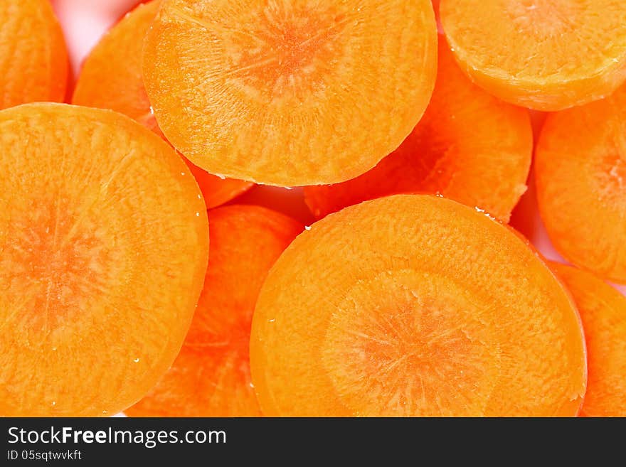 Raw carrot slices on a whole background