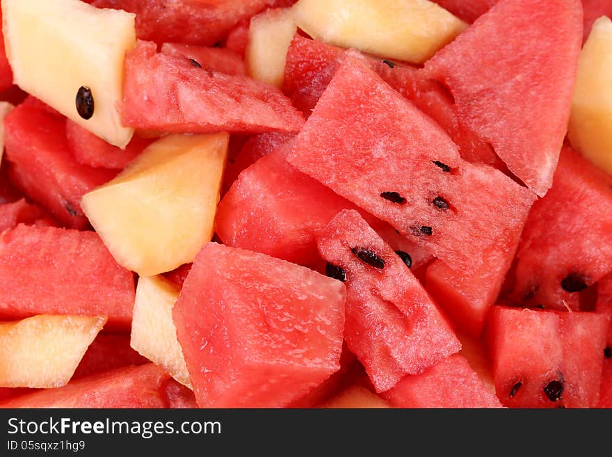 Bunch of sliced watermelons and melons close up.