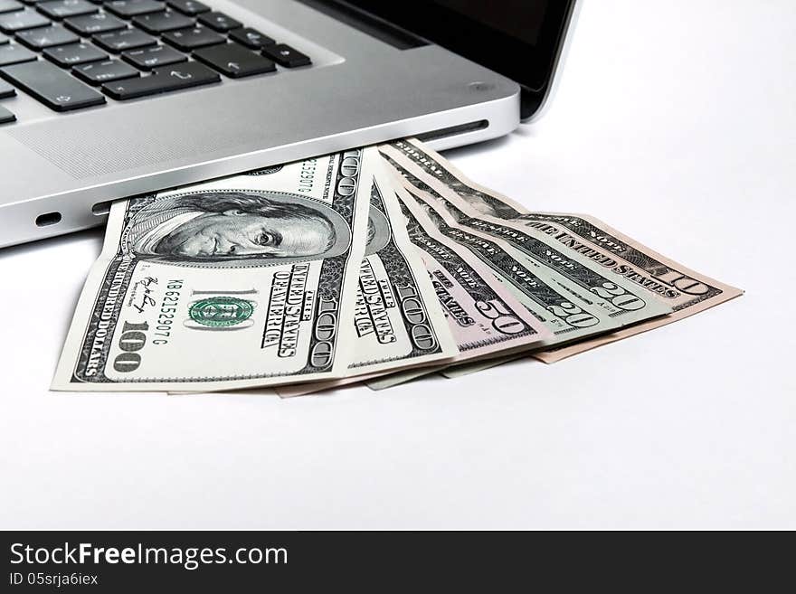 Laptop with money on white background. Laptop with money on white background